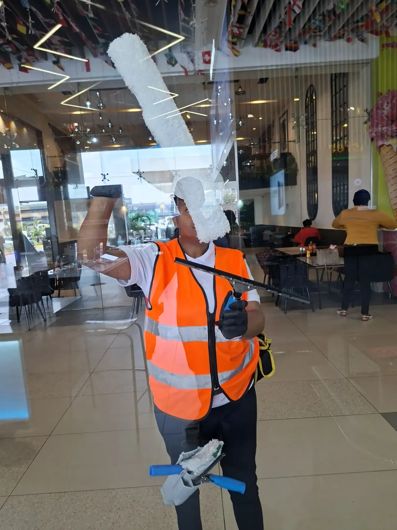 Dirty Nuvora technician cleaning commercial glass